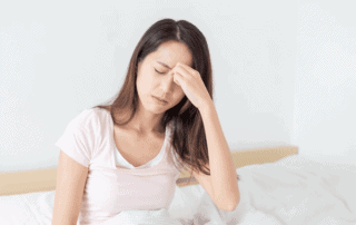 woman holding nose