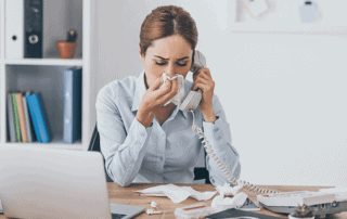 woman with a runny nose with a tissue