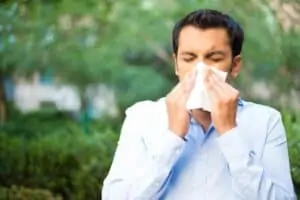 Fall Allergies Man Blowign nose into tissue