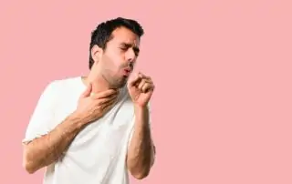 man coughing from cigarettes